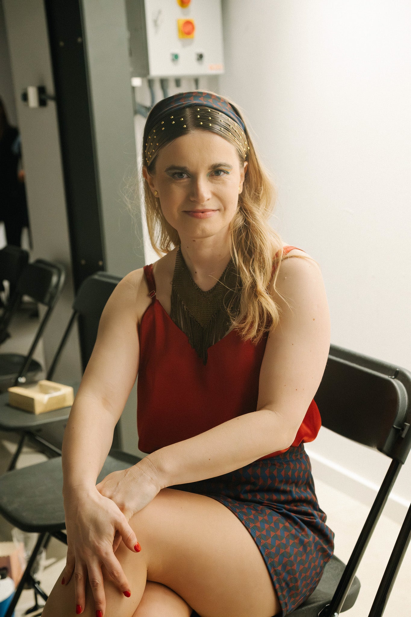 Luna Top in red and Maracana Skort. Seated view showing strap and neckline.