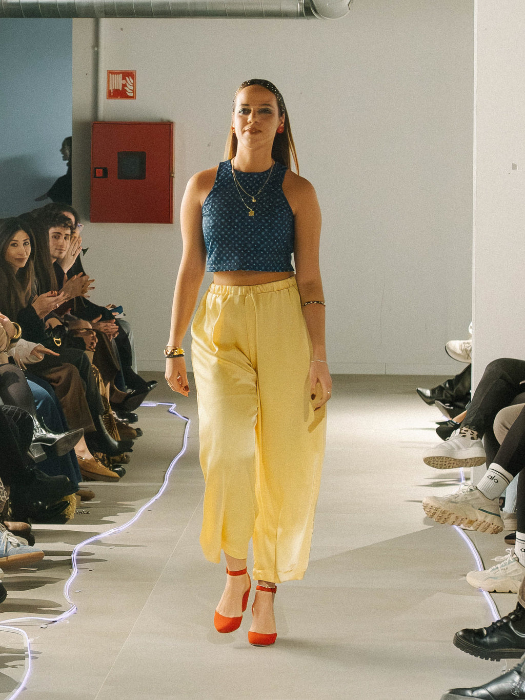 Catwalk show. Candlelight Pants Yellow — sustainable wide-leg trousers by Halfen House. Model wearing Gracia Nights Summer top,  and yellow candlelights pants.