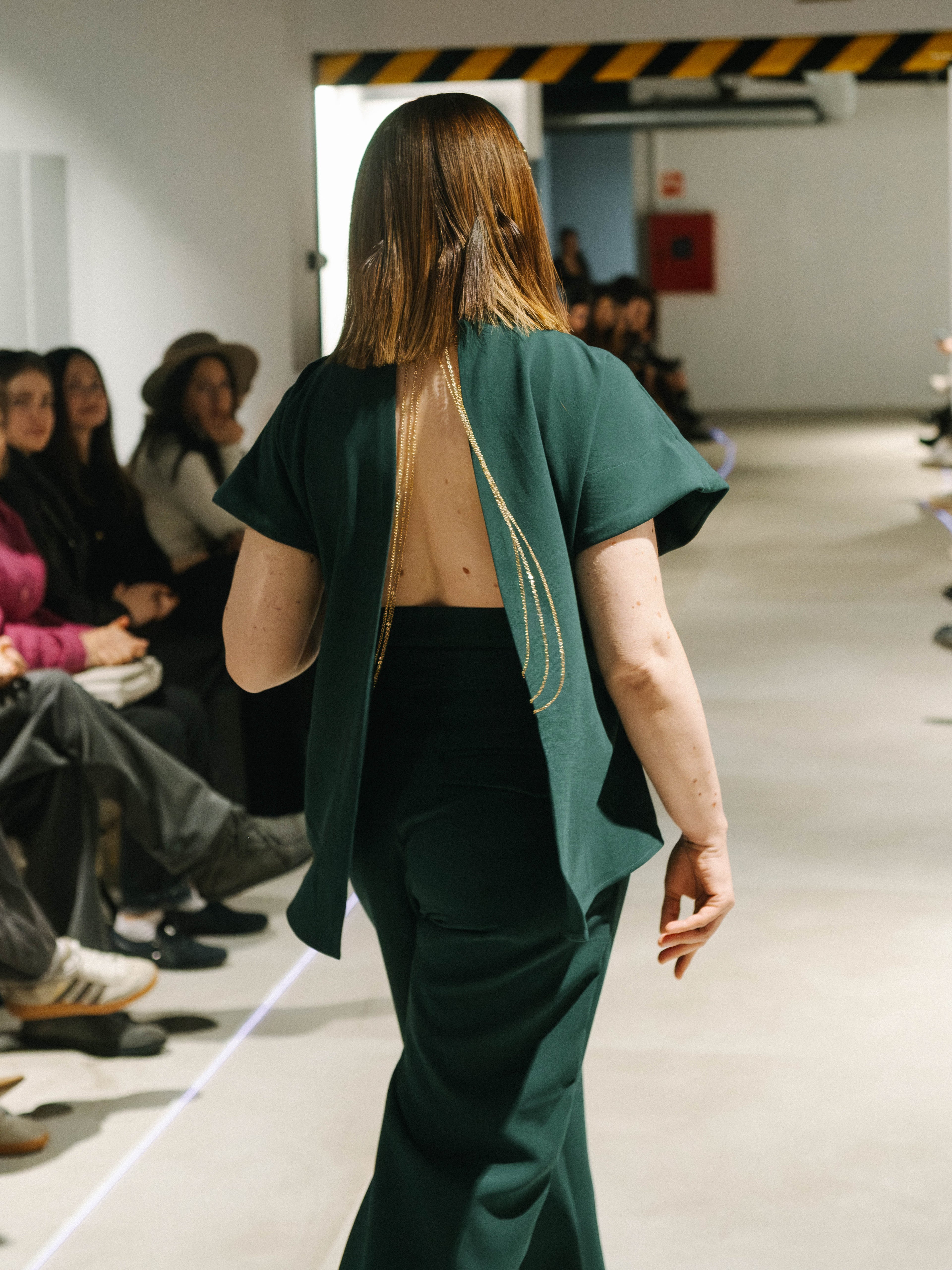 Back view of dark green Bossy Pants and matching Diva Top highlighting a sculpted high waist and fluid movement.